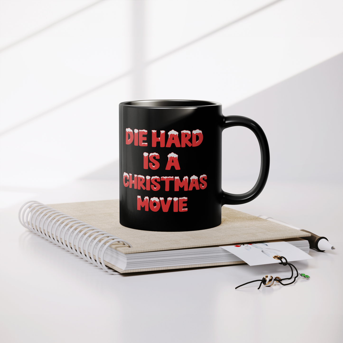Die_Hard_Is_A_Christmas_Movie_-_11oz_Mug_Lifestyle_Notebook_Mockup.png