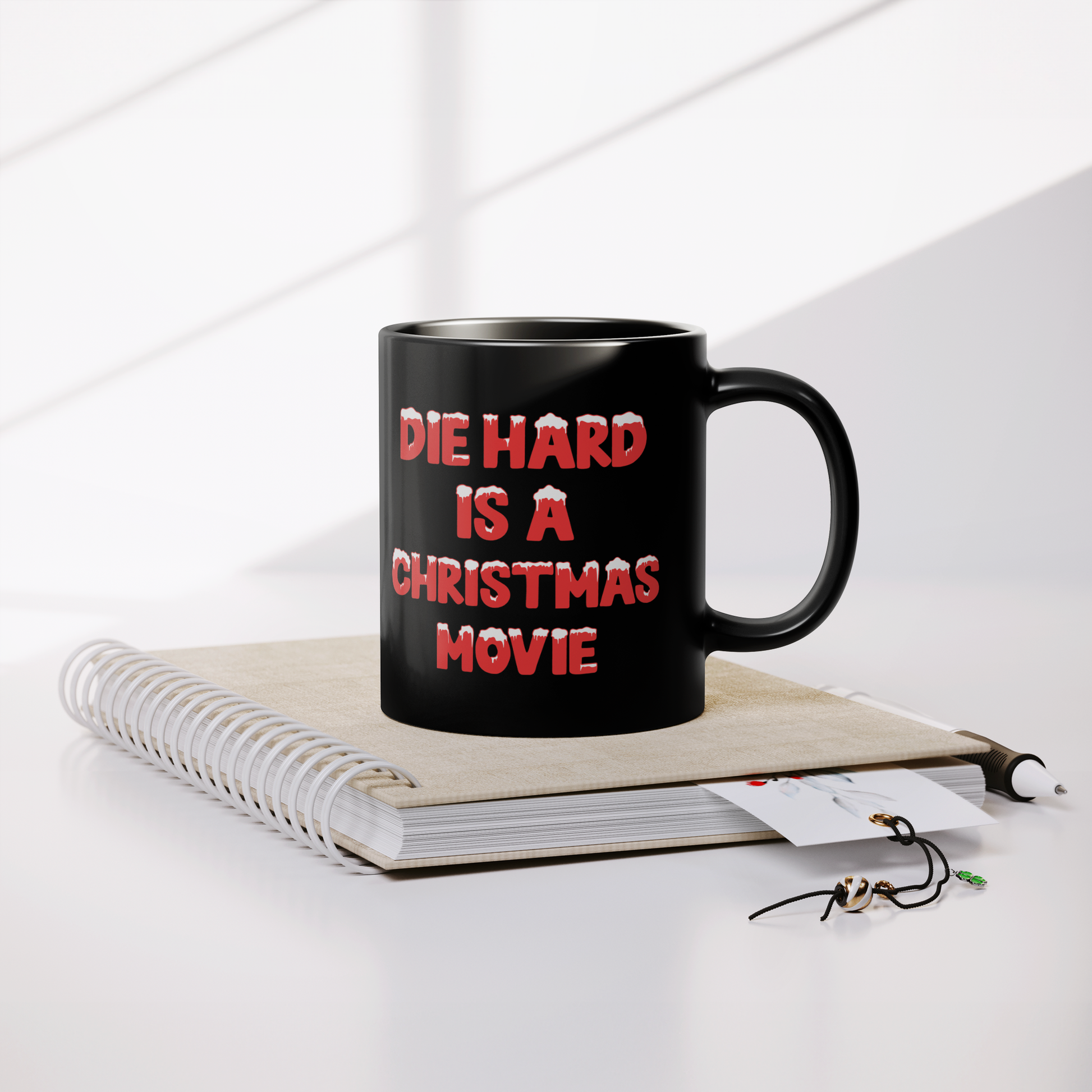 Die_Hard_Is_A_Christmas_Movie_-_11oz_Mug_Lifestyle_Notebook_Mockup.png