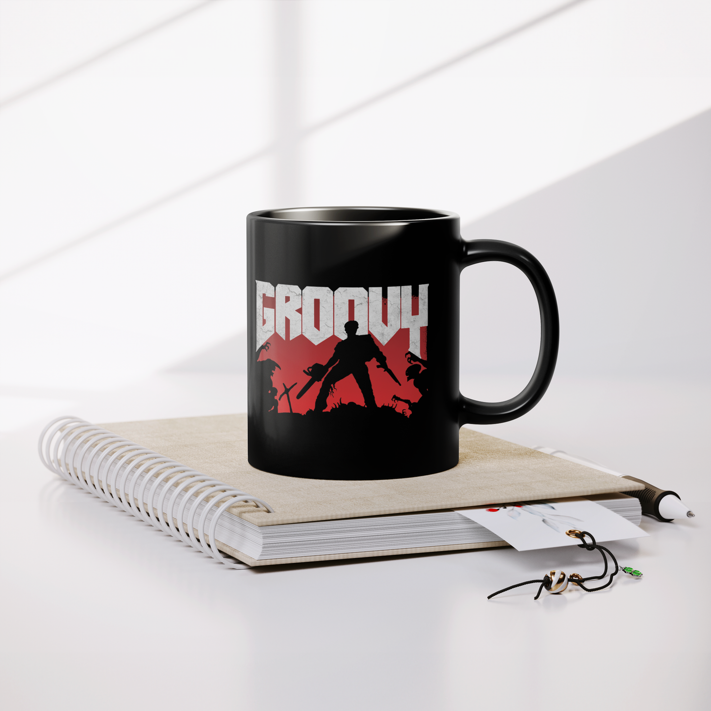 Evil_Dead_Groovy_Doom_-_11oz_Mug_Lifestyle_Notebook_Mockup.png