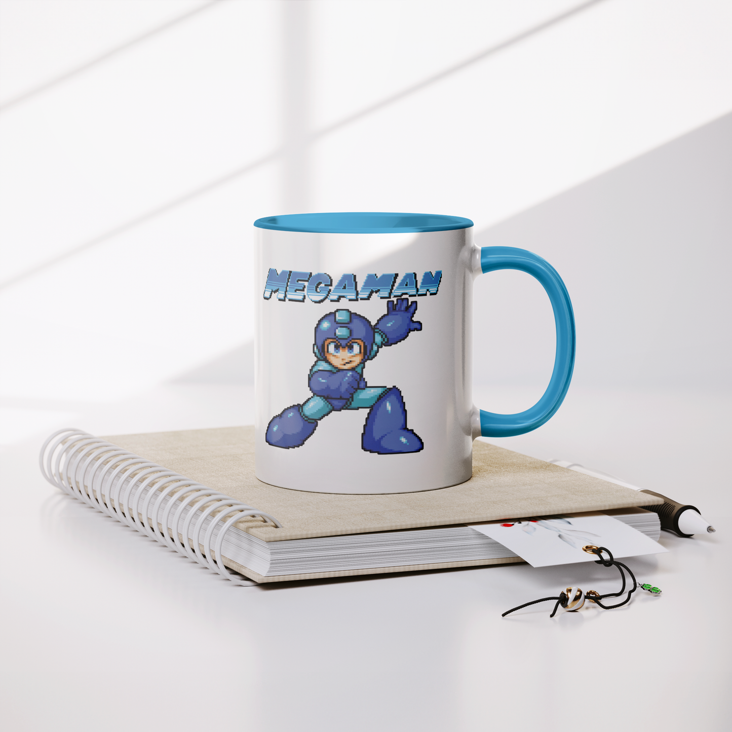 Mega_Man_8-Bit_-_11oz_Mug_Lifestyle_Notebook_Mockup.png