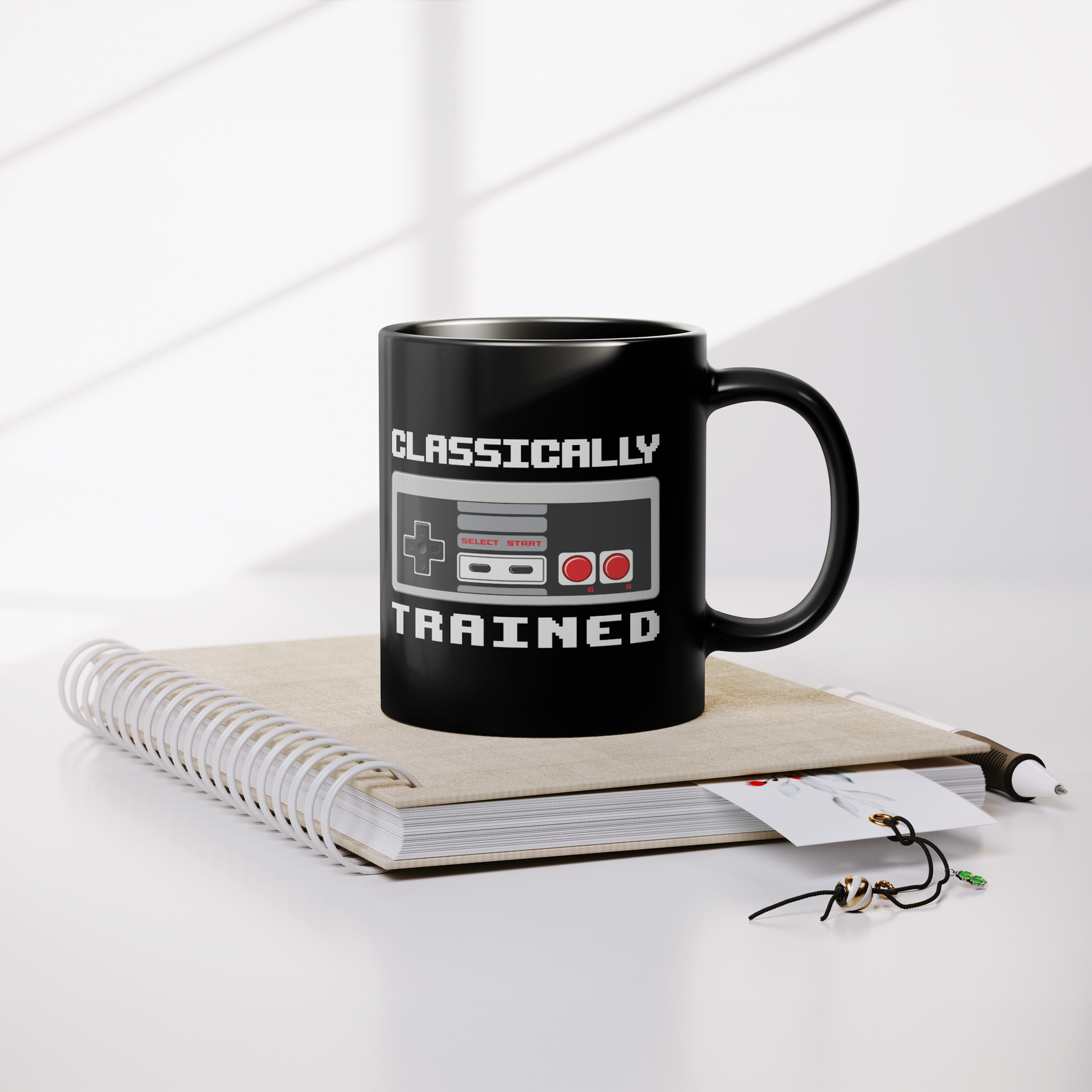 NES_Controller_Clasically_Trained_-_11oz_Lifestyle_Notebook_Mockup.png