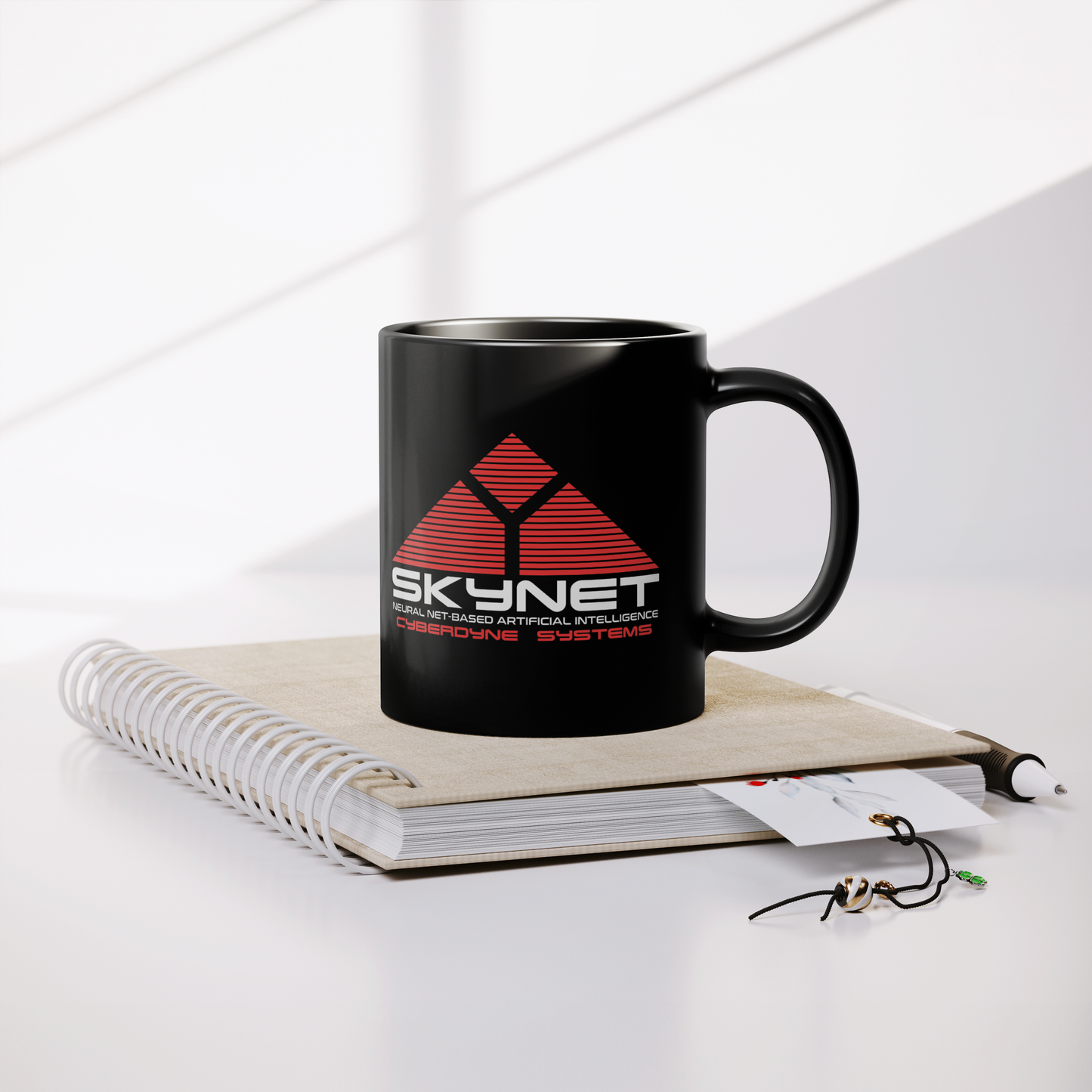 Skynet_Cyberdyne_Systems_-_11oz_Mug_Lifestyle_Notebook_Mockup.png