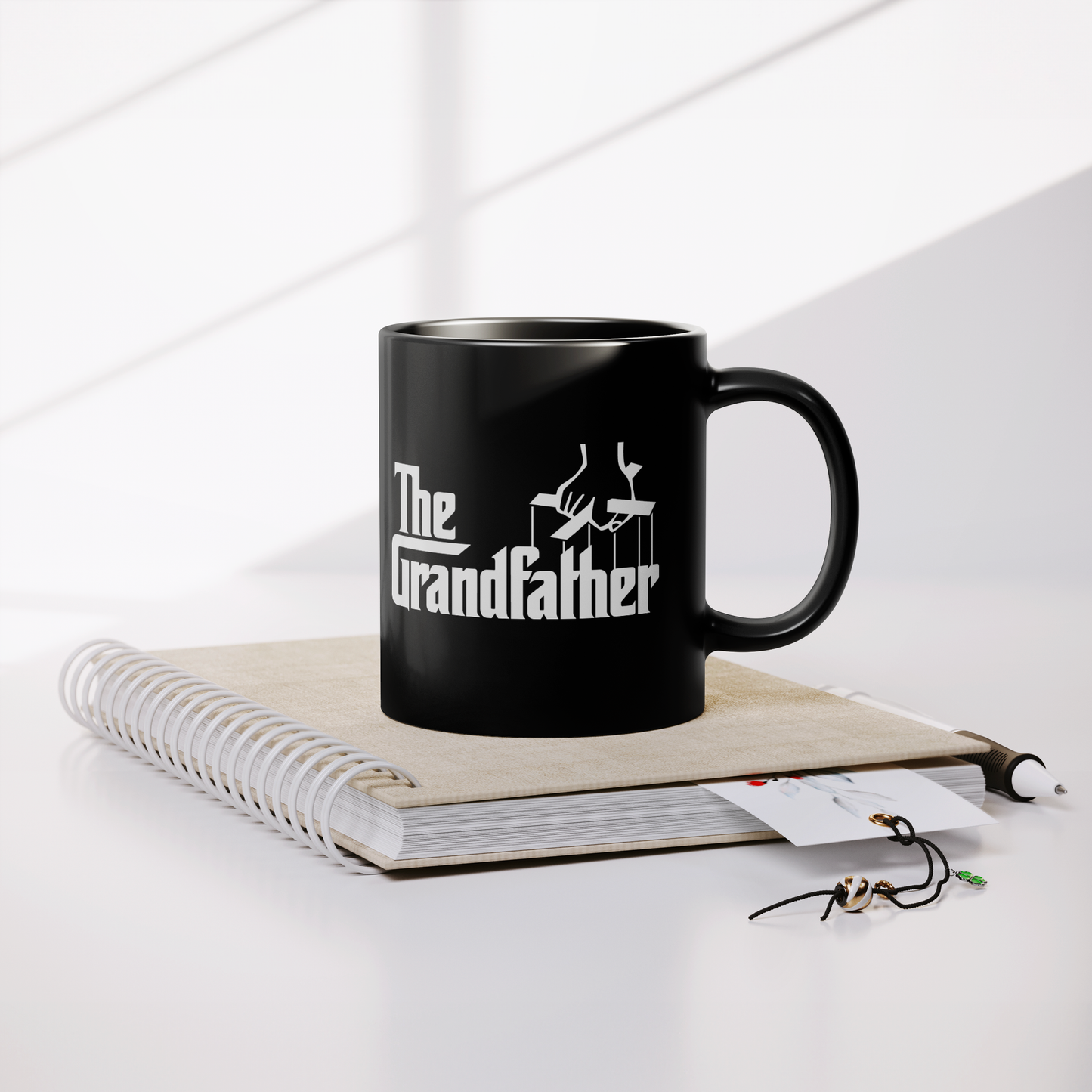 The_Grandfather_-_11oz_Coffee_Mug_Lifestyle_Notebook_Mockup.png